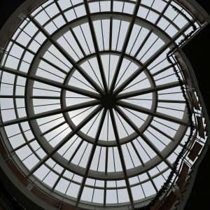 A striking geometric glass ceiling design creates an artistic architectural focal point.